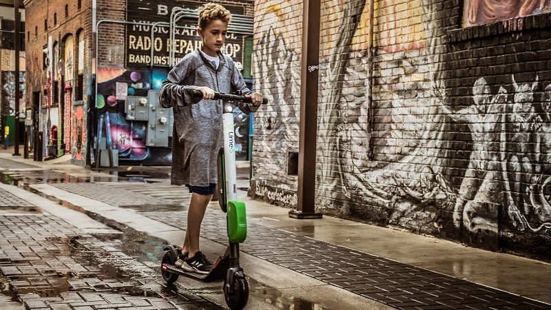 Junge auf Lime Scooter USA Straße